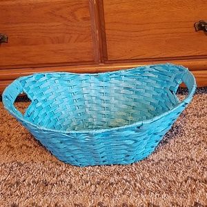 Bright blue woven wicker style basket.